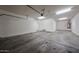 Spacious two car garage with painted walls, overhead lighting, and an automatic door opener at 10036 E Naranja Ave, Mesa, AZ 85209