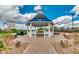 A beautifully designed white gazebo with a clock tower sits on a paved walkway at 10036 E Naranja Ave, Mesa, AZ 85209