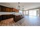 Open kitchen featuring wooden cabinetry, stainless appliances, granite counters, and a central island at 10036 E Naranja Ave, Mesa, AZ 85209