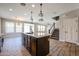 Spacious kitchen featuring granite countertops, stainless steel appliances, and an island with sink and drawers at 10036 E Naranja Ave, Mesa, AZ 85209