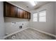 Well-equipped laundry room with ample cabinet space, convenient hookups, and natural light at 10036 E Naranja Ave, Mesa, AZ 85209