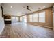 Spacious living room with tile floors, ceiling fan, and natural light from the large windows at 10036 E Naranja Ave, Mesa, AZ 85209