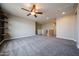 A spacious loft area with carpet, neutral walls, and access to other rooms at 10036 E Naranja Ave, Mesa, AZ 85209