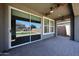 Covered patio includes ceiling fans and has views of the artificial lawn and backyard at 10036 E Naranja Ave, Mesa, AZ 85209