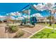 Community playground featuring a slide and sun shade with a clubhouse in the background at 10036 E Naranja Ave, Mesa, AZ 85209