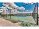 Well-maintained community tennis court surrounded by black fencing and landscaping, perfect for active residents at 10036 E Naranja Ave, Mesa, AZ 85209