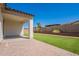 Covered back patio that overlooks a well-maintained lawn and a block wall at 10348 E Tupelo Ave, Mesa, AZ 85212