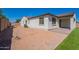 The exterior of the home features a tiled roof, a stucco wall, an irrigation system and a small patio at 10348 E Tupelo Ave, Mesa, AZ 85212