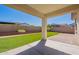 This backyard features a manicured lawn, a covered patio and a block fence providing privacy at 10348 E Tupelo Ave, Mesa, AZ 85212