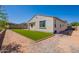 The exterior features a green lawn, and a stucco exterior with decorative roof tiles, ready for new landscaping at 10348 E Tupelo Ave, Mesa, AZ 85212