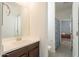Bathroom with a vanity with a white countertop, dark wood cabinets, and access to the bath area at 10348 E Tupelo Ave, Mesa, AZ 85212