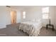 Spacious bedroom with a large window allowing natural light with neutral walls and carpet flooring at 10348 E Tupelo Ave, Mesa, AZ 85212