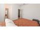 Bright bedroom showing access to other areas through doorways, natural lighting, and carpet flooring at 10348 E Tupelo Ave, Mesa, AZ 85212