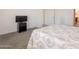 Comfortable bedroom with grey carpet flooring and a TV stand to hold a modern black flat screen at 10348 E Tupelo Ave, Mesa, AZ 85212