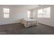 Bright, carpeted bedroom with large windows offering plenty of natural light at 10348 E Tupelo Ave, Mesa, AZ 85212