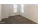 Bright bedroom with neutral walls, carpet, and large windows that offer plenty of natural light at 10348 E Tupelo Ave, Mesa, AZ 85212