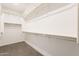 Walk-in closet provides ample space for organization with carpet floors and multiple shelves at 10348 E Tupelo Ave, Mesa, AZ 85212