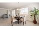 Bright dining area with a round table, chandelier, and lots of natural light at 10348 E Tupelo Ave, Mesa, AZ 85212