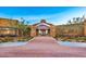 Inviting entrance with stone accents, lush greenery, and a well-maintained brick paver walkway at 10348 E Tupelo Ave, Mesa, AZ 85212