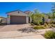 Charming single-story home featuring a paver driveway, two-car garage, and desert landscaping at 10348 E Tupelo Ave, Mesa, AZ 85212