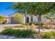 Single-story home with stucco and a brick-paver driveway complemented with lush landscaping at 10348 E Tupelo Ave, Mesa, AZ 85212