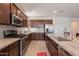 Well-organized kitchen with stainless steel appliances, granite countertops, and lots of storage at 10348 E Tupelo Ave, Mesa, AZ 85212