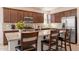 Well-lit kitchen with granite countertops, a stainless steel microwave, and a breakfast bar with seating at 10348 E Tupelo Ave, Mesa, AZ 85212