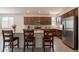 Updated kitchen with granite countertops, stainless steel appliances, and a breakfast bar with seating at 10348 E Tupelo Ave, Mesa, AZ 85212