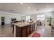 Open concept kitchen with a breakfast bar, stainless appliances, and granite countertops overlooking living area at 10348 E Tupelo Ave, Mesa, AZ 85212