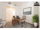 Bright staged office space with a desk, chair, and view of a comfortable sitting area at 10348 E Tupelo Ave, Mesa, AZ 85212