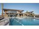 A luxurious pool with ample seating areas and modern architecture at 10348 E Tupelo Ave, Mesa, AZ 85212