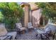 Inviting back patio with cushioned chairs and desert landscaping at 10650 E Palladium Dr, Mesa, AZ 85212