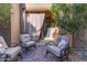 Cozy back patio setting with comfortable cushioned chairs at 10650 E Palladium Dr, Mesa, AZ 85212