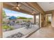 Expansive backyard with a pool, fireplace, and cozy patio seating at 10650 E Palladium Dr, Mesa, AZ 85212