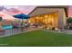 Inviting backyard patio with comfortable seating, lush greenery, and a serene pool view, ideal for outdoor gatherings at 10650 E Palladium Dr, Mesa, AZ 85212