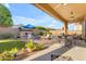 Spacious covered patio with outdoor seating and a charming backyard area, perfect for entertaining at 10650 E Palladium Dr, Mesa, AZ 85212