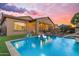 Serene backyard with a sparkling pool, basketball hoop, and comfortable seating, perfect for Gathering fun and relaxation at 10650 E Palladium Dr, Mesa, AZ 85212