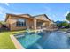 The backyard features a refreshing pool, covered patio, and plenty of space for outdoor seating and entertaining at 10650 E Palladium Dr, Mesa, AZ 85212