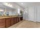 Large bathroom featuring wood cabinets with granite countertops, a vanity area, and glass door shower at 10650 E Palladium Dr, Mesa, AZ 85212