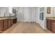 Spacious bathroom features wood-look tile floors, wood cabinets, granite countertops and a glass door shower at 10650 E Palladium Dr, Mesa, AZ 85212