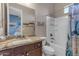 Bathroom featuring granite countertops, white cabinetry, and a shower-tub combo, complemented by a large mirror at 10650 E Palladium Dr, Mesa, AZ 85212