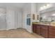 Neutral toned bathroom featuring granite counters, wood look flooring, white doors and framed artwork at 10650 E Palladium Dr, Mesa, AZ 85212