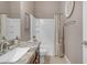 Bathroom with a large mirror, granite countertop, wood cabinets, and a shower-tub combination at 10650 E Palladium Dr, Mesa, AZ 85212