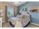 Designer bedroom with elegant decor, tufted headboard, and window with natural light at 10650 E Palladium Dr, Mesa, AZ 85212