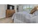 Cozy bedroom with shuttered windows, neutral walls and a television atop a dresser with drawers at 10650 E Palladium Dr, Mesa, AZ 85212