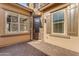 Charming front porch featuring stone accents, decorative windows, and a stylish front door at 10650 E Palladium Dr, Mesa, AZ 85212