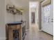Inviting hallway with elegant console table, decorative wall sconce, and a view into a brightly lit room at 10650 E Palladium Dr, Mesa, AZ 85212