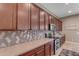 Kitchen showcasing wood cabinets, quartz countertops, stainless appliances, and unique tile backsplash at 10650 E Palladium Dr, Mesa, AZ 85212