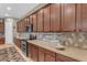 Spacious kitchen featuring wood cabinets, quartz countertops, and stainless steel microwave and oven at 10650 E Palladium Dr, Mesa, AZ 85212
