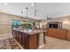 Open concept kitchen featuring an island with bar stool seating that opens to the living room and backyard at 10650 E Palladium Dr, Mesa, AZ 85212